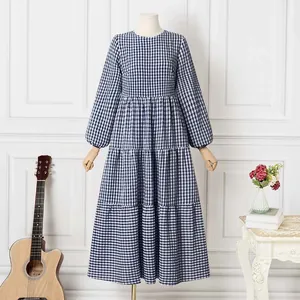 Long-sleeved blue and white gingham tiered maxi dress with puff sleeves on mannequin