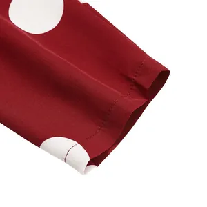 Macro detail of high-quality stitching on red vintage sun dress with white polka dots
