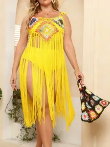 Plus size crochet beach cover-up with vibrant colorful patterns and long yellow tassels details