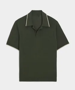 Detailed view of dark green knit Polo shirt with cream contrast tipping on collar and cuffs