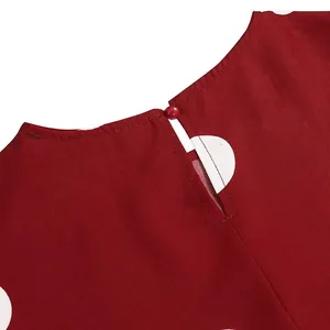 Detail of vintage red polka dot dress featuring a back keyhole with button closure.