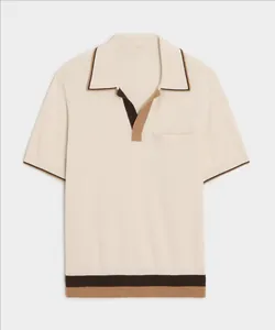 Front view detail of a men's knitted polo shirt with contrast collar and hem stripes.