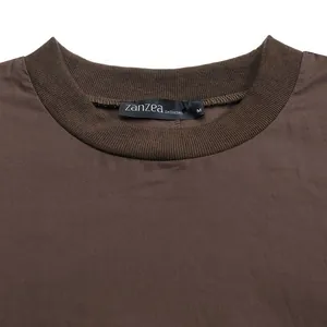 Close-up of brown dress featuring a ribbed round neckline and Zanzea brand tag.