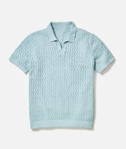 Detailed view of light blue men's polo shirt featuring an intricate zigzag pointelle knit