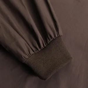 Close-up macro view of the brown elastic ribbed cuff detail on a casual long sleeve dress