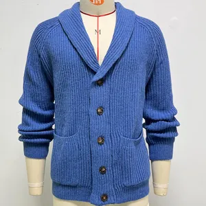 Macro view of blue men's knitted cardigan showing shawl collar and wood-like buttons