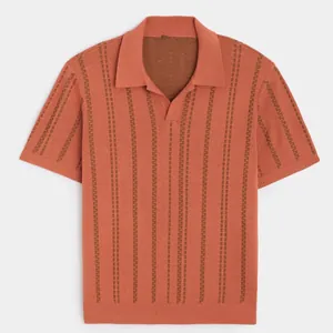 Close-up of a men's knit polo shirt in burnt orange with vertical textured stripes