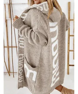 Detailed view of long beige knit cardigan with white letter jacquard and hood
