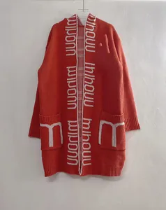 Detailed view of the orange long hooded cardigan featuring white letter knit patterns