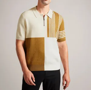 Détail d'un polo en maille color-block pour homme avec fermeture éclair et rayures.
