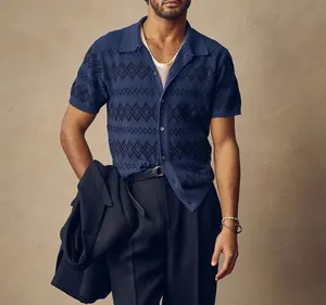 Close-up of black diamond jacquard pattern on blue knitted short sleeve Polo cardigan