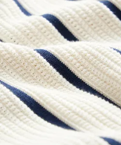 Macro detail showing the soft texture of blue and white striped knitted fabric