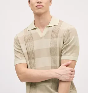 Close-up detail of a beige knit Polo shirt featuring a striped pointelle pattern and V-neck