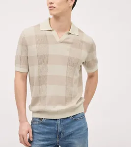 Detailed shot of men's textured knit polo shirt in beige with stylish checkered pattern