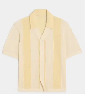 Macro view of men's hollow-out knit polo shirt texture with pale yellow stripes