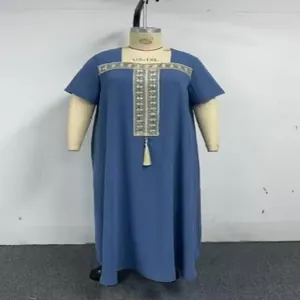 Detailed view of the intricate gold embroidery and tassel on this blue plus size dress