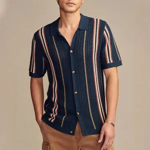 Professional shot of a men's navy blue striped knit polo shirt with hollow-out mesh texture