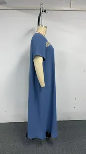 Side view of a blue plus size maxi dress with gold embroidery details on a mannequin.