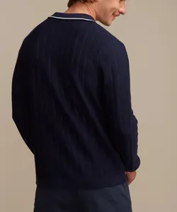 Close-up of the back texture of a navy blue hollow-out knit long-sleeved Polo shirt.