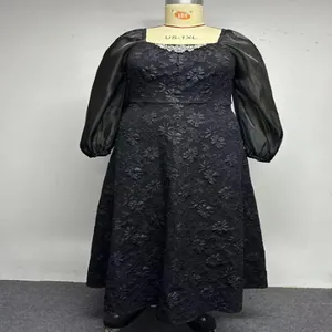 Detailed view of black jacquard plus-size dress with rhinestone square neck and puff sleeves