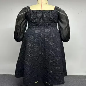 Detail view of black jacquard plus-size dress with elegant puff sleeves and square neck