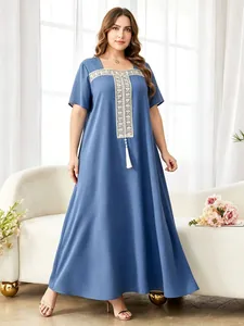 Elegant plus size blue maxi dress featuring intricate white embroidery and tassel