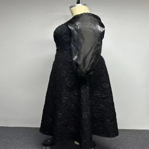 Detail view of a black jacquard plus-size maxi dress featuring elegant satin puff sleeves