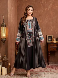 Detailed view of ethnic print black plus-size maxi dress in rustic indoor setting