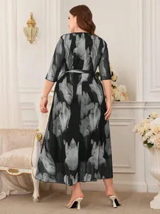 Rear view of elegant plus size black and grey floral print mesh midi dress with waist tie