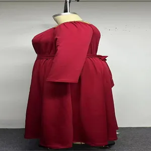 Side view of a plus-size red long sleeve dress featuring an elegant waist tie and flared skirt.