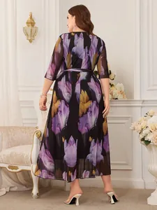 Detailed back view of a plus size purple floral print mesh dress featuring a waist tie