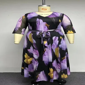 Detail view of a plus-size V-neck mesh dress with vibrant purple floral print.