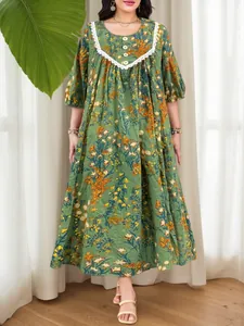Close-up of vintage floral print maxi dress featuring lace trim and elegant lantern sleeves