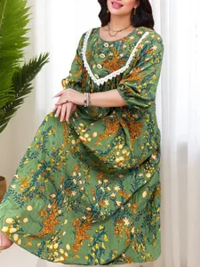 Detail of a green vintage floral maxi dress with white lace collar and puff sleeves.