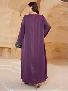 Detail back view of a plus size purple maxi dress with ethnic embroidered cuffs