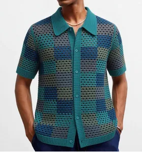 Detail showing the hollow-out checkerboard crochet texture of the men's knit polo shirt.