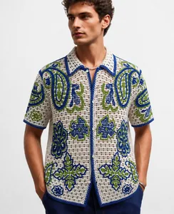 Detailed shot of men's hollow-out crochet knit shirt with vibrant blue and green patterns