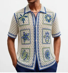 Detail view of men's crochet knit shirt with vibrant blue and green tropical patterns