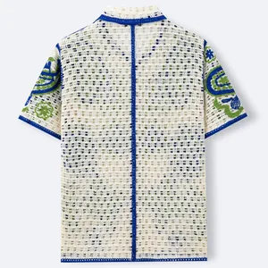 Back view of men's hollow knit crochet polo shirt with embroidered Hawaiian style sleeves