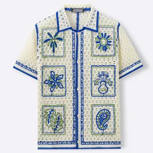 Men's resort style crochet hollow knit shirt with vibrant floral embroidery.