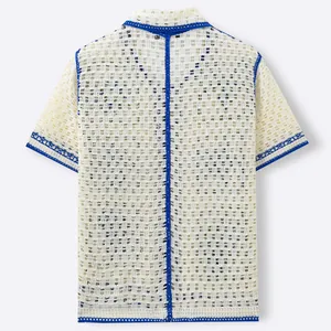 Men's off-white crochet knit polo shirt with blue trim and hollow-out resort style design.