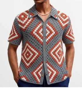 Detail view of men's geometric crochet knit polo shirt with terracotta and blue patterns