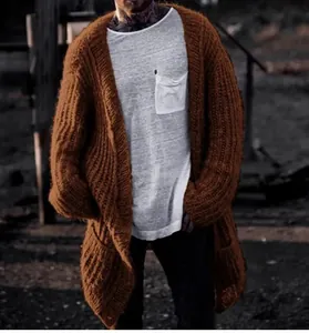 Detailed view of men's oversized brown chunky knit cardigan with ribbed texture
