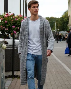Street style view of men's long grey hooded knitted cardigan with casual jeans.