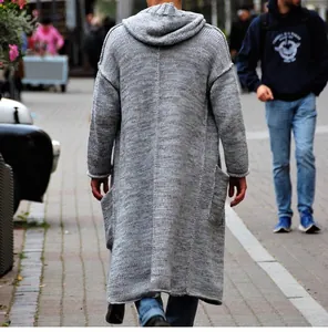 Detailed back view of a long grey hooded knitted cardigan for men in a street setting.