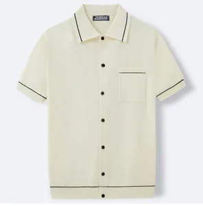 Close-up of cream short-sleeve knit polo shirt with elegant black contrast stripes