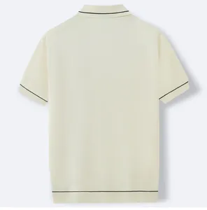 Back view of cream knit polo shirt with black contrast tipping on collar and sleeves.