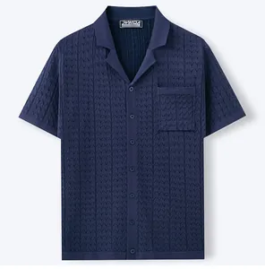 Close-up of navy blue men's Cuban collar knit shirt with jacquard texture and pocket