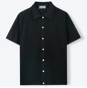 Detailed view of the black men's knit polo cardigan featuring a delicate jacquard pattern