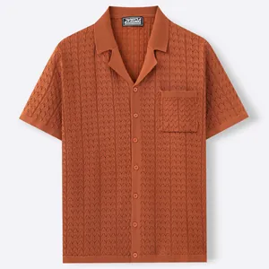 Rust orange short sleeve knit shirt with Cuban collar and jacquard pattern detailing.